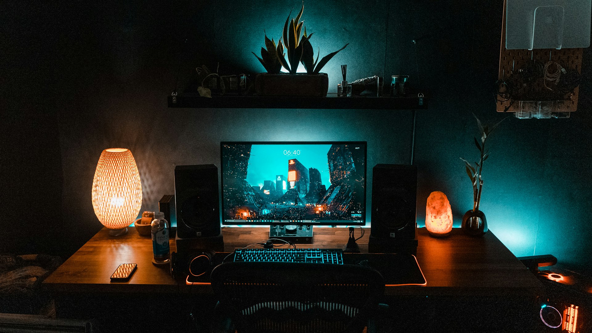 Neon-lit gaming battlestation glowing in a dark room
